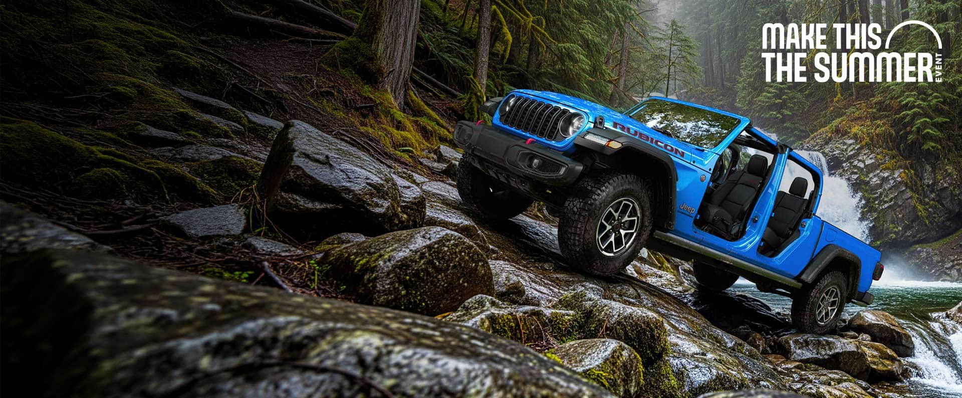 A blue 2026 Jeep Gladiator Rubicon with its doors and top removed, parked on a steep, rocky trail, just above a rapid stream with a waterfall in the background. Make This The Summer Event.