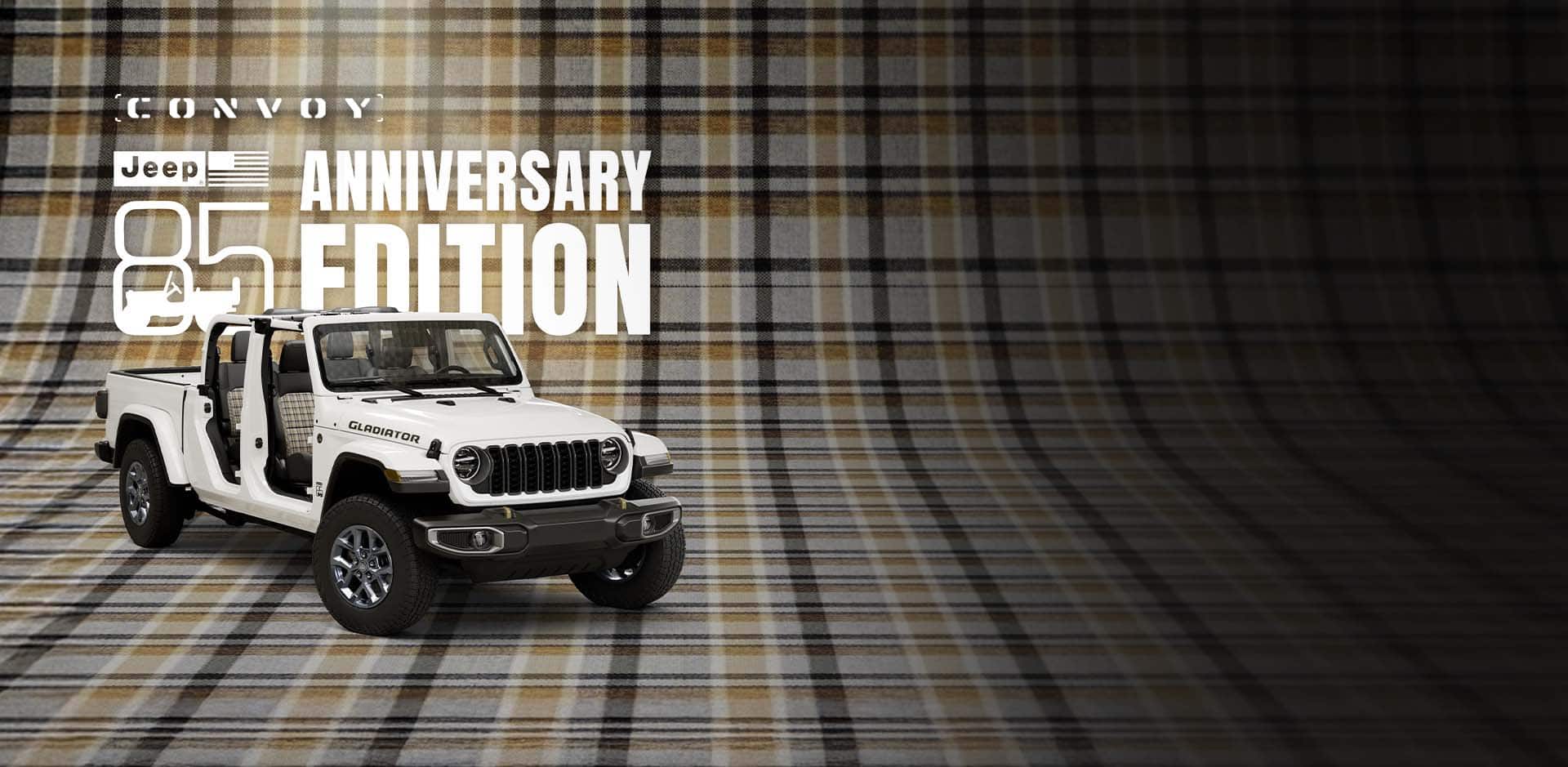 A passenger-side front angle of a white 2026 Jeep Gladiator 85th Anniversary Edition with its doors and top removed, revealing plaid inserts on the front and rear seats, parked on a seamless plaid surface that extends up the wall behind it. Jeep 85 Anniversary Edition. Convoy.
