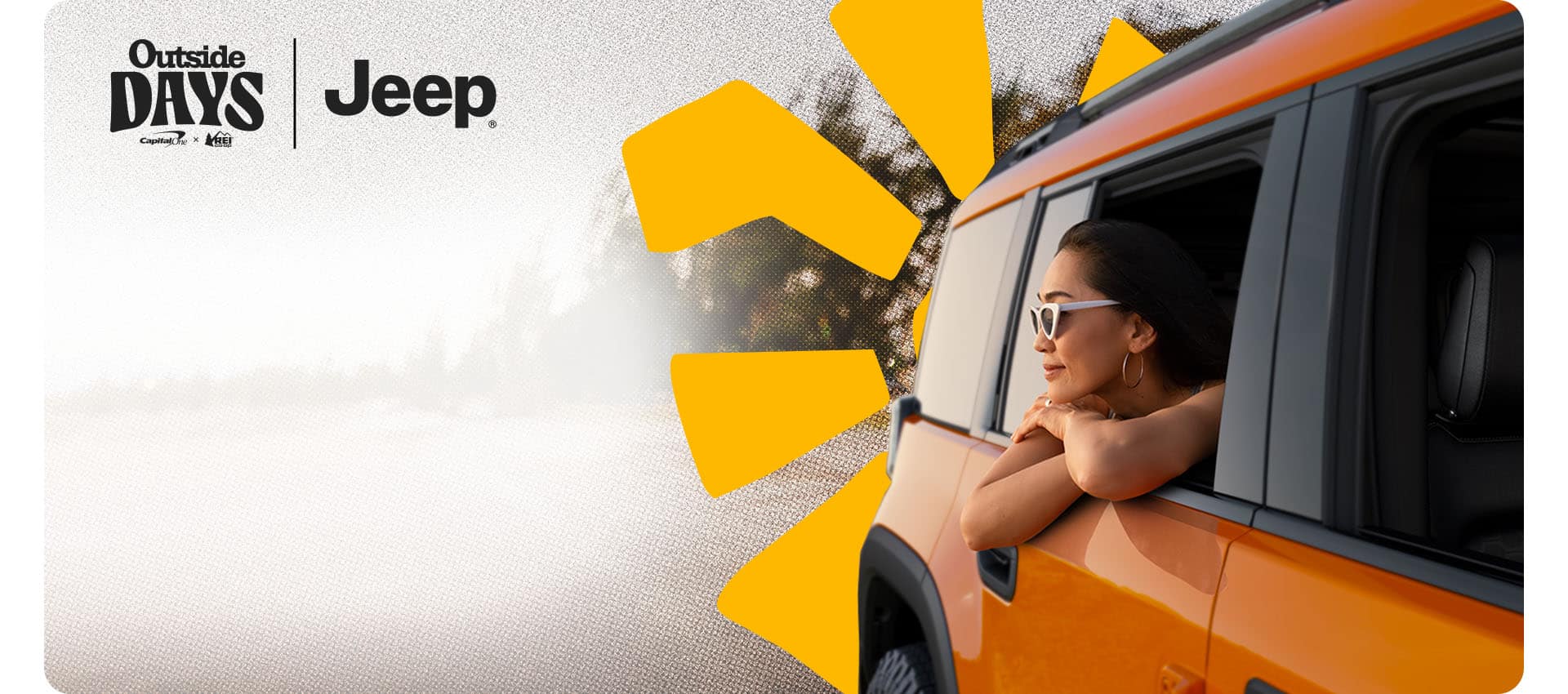 An orange 2026 Jeep Recon with a woman looking out the window from the passenger-side rear seat. Outside Days. Jeep. Capital One. REI Co-op.