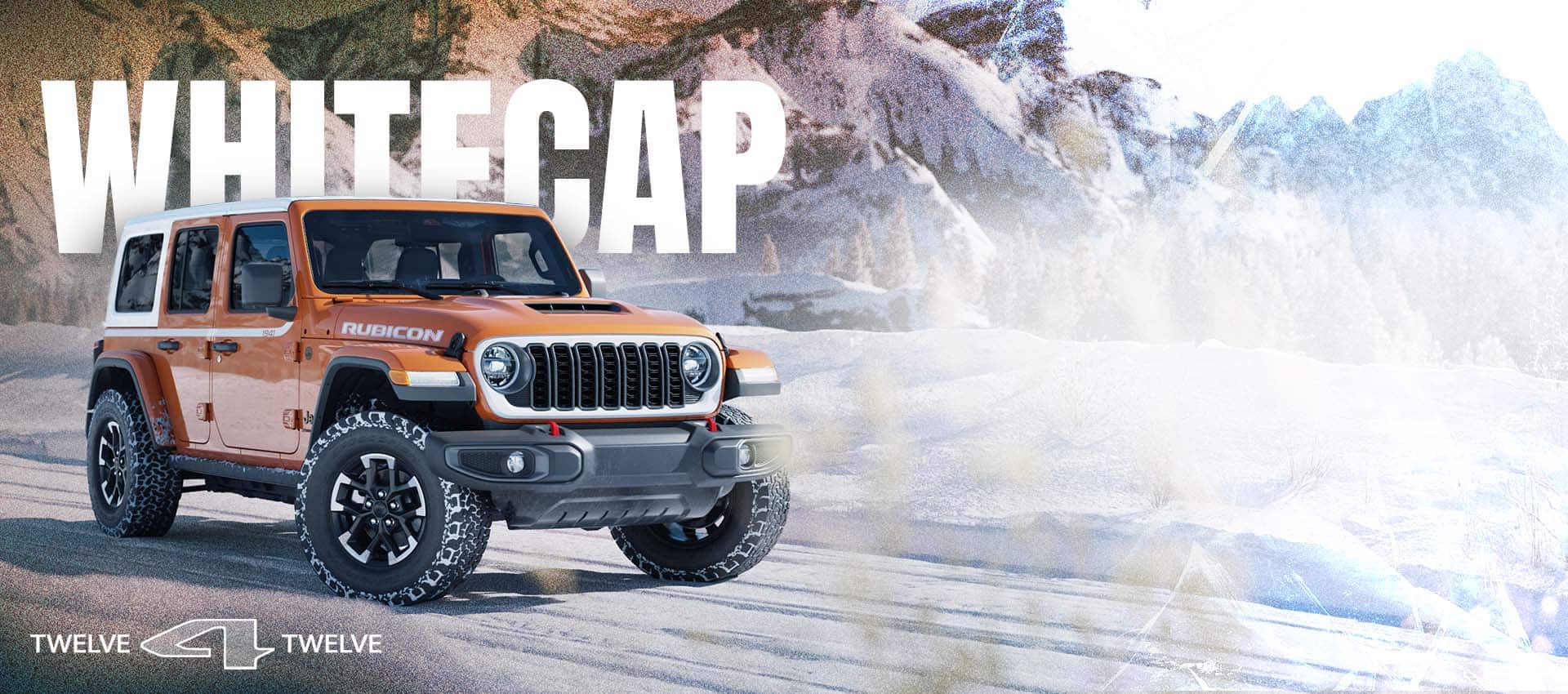 An orange 2026 Jeep Wrangler Rubicon traveling down a snow-covered road with mountains in the background. Whitecap. 12 for 12.