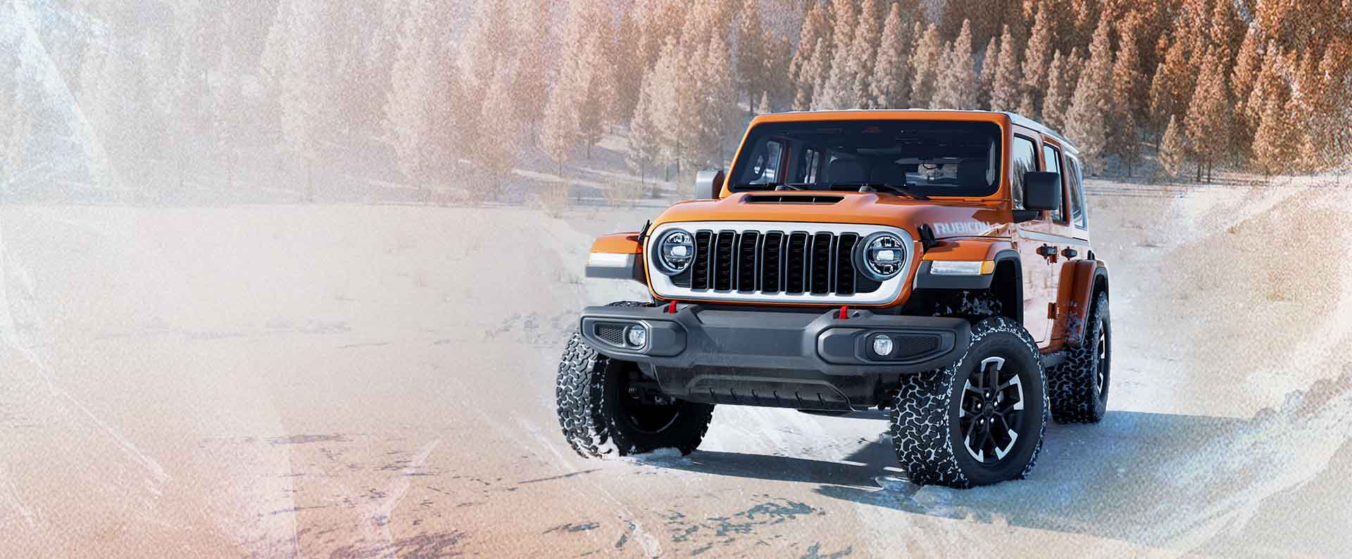 An orange 2026 Jeep Wrangler Rubicon Whitecap traveling down a snow-covered road with a forest of evergreens in the background.
