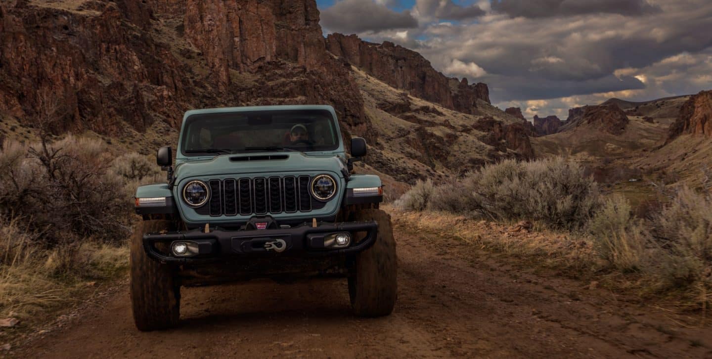 The 2022 Jeep Wrangler Sahara being driven on a city street.