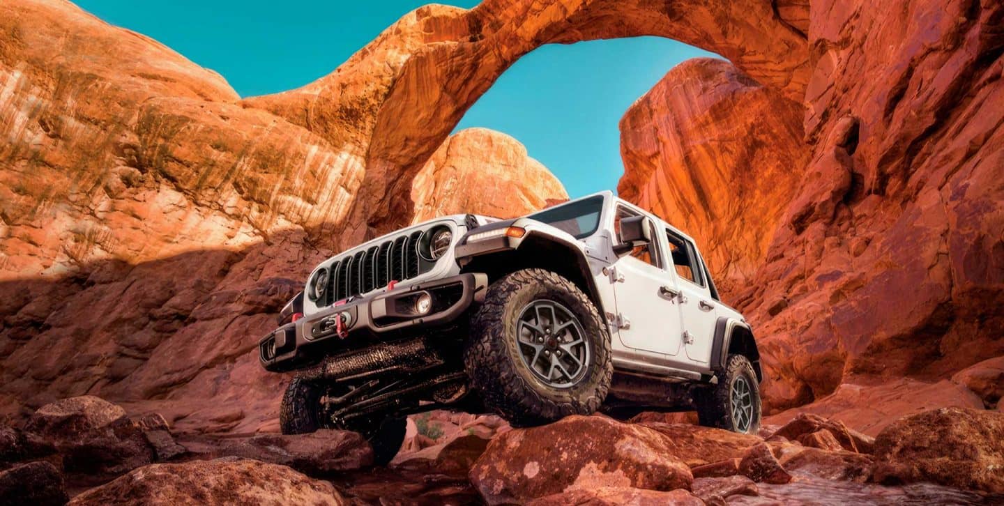 The 2022 Jeep Wrangler Rubicon climbing a steep, rocky slope.