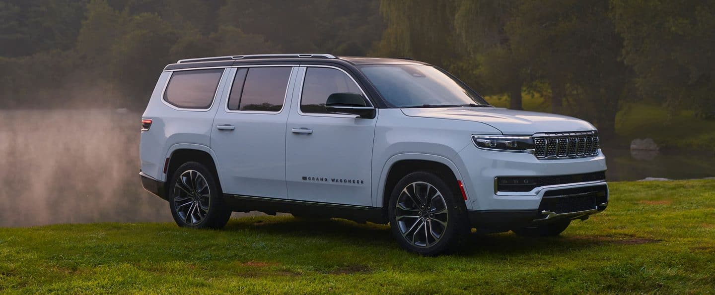 The 2023 Grand Wagoneer Series III parked off-road in a misty field.