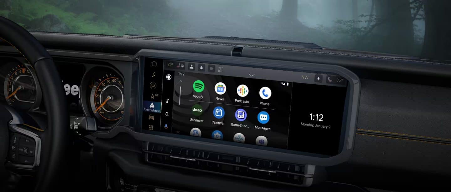 A close-up of the Uconnect 5 touchscreen in the 2024 Jeep Wrangler displaying a series of Android Auto selections and the current date and time.