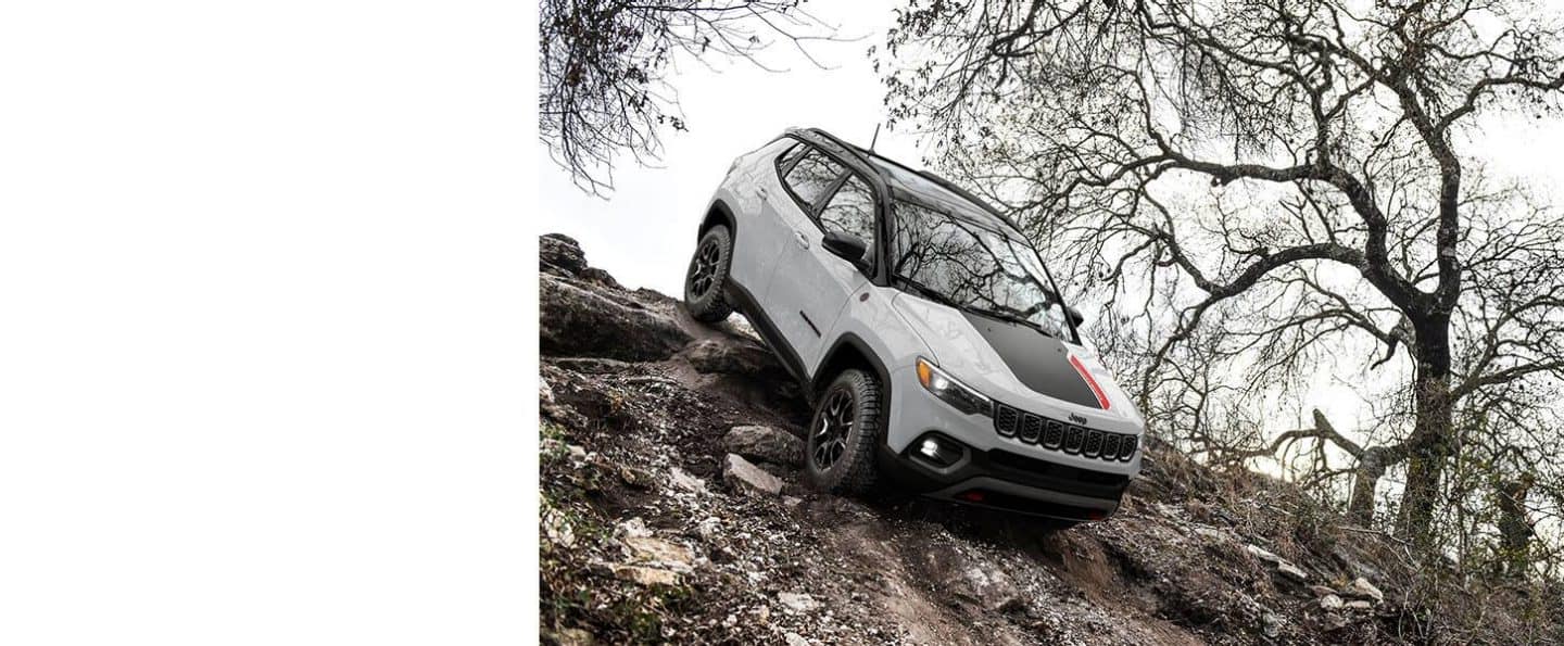 Un Jeep Compass Trailhawk 2024 descendiendo una colina muy empinada fuera de la carretera.