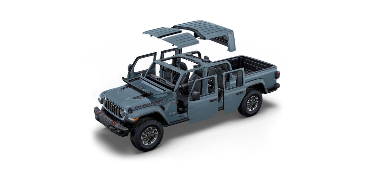 Un Jeep Gladiator Rubicon X 2025 gris sin el techo ni las puertas y con el parabrisas plegado.