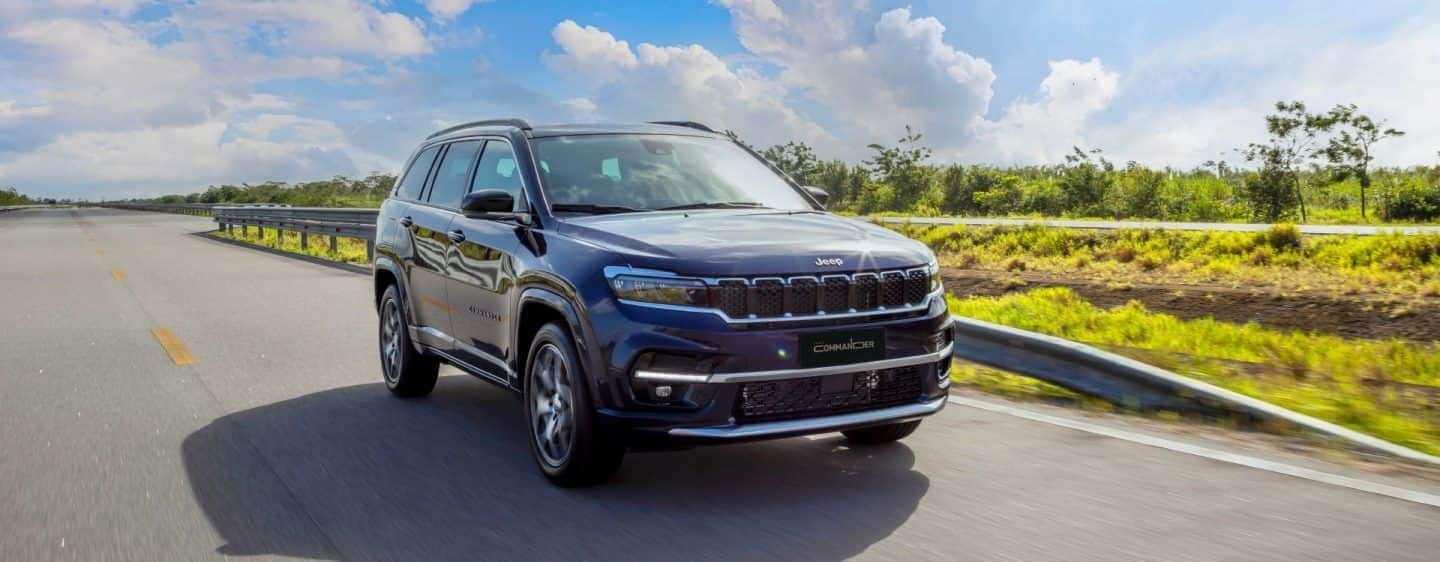 A 2023 Jeep Cherokee Altitude Lux being driven on a highway.