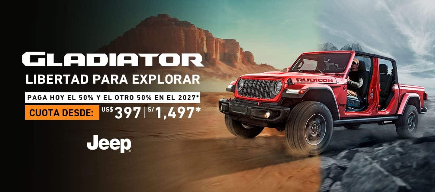 A 2024 Jeep Wrangler Rubicon 4xe with its doors and roof removed, being driven on a sandy trail off-road, with huge boulders on both sides.