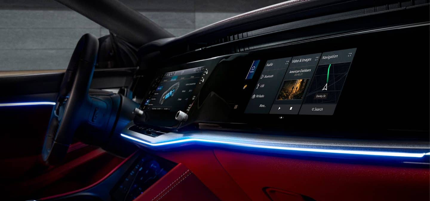 Display The interior of the 2024 Jeep Wagoneer S Launch Edition focusing on the steering wheel, Uconnect touchscreen and Passenger Interactive Display.