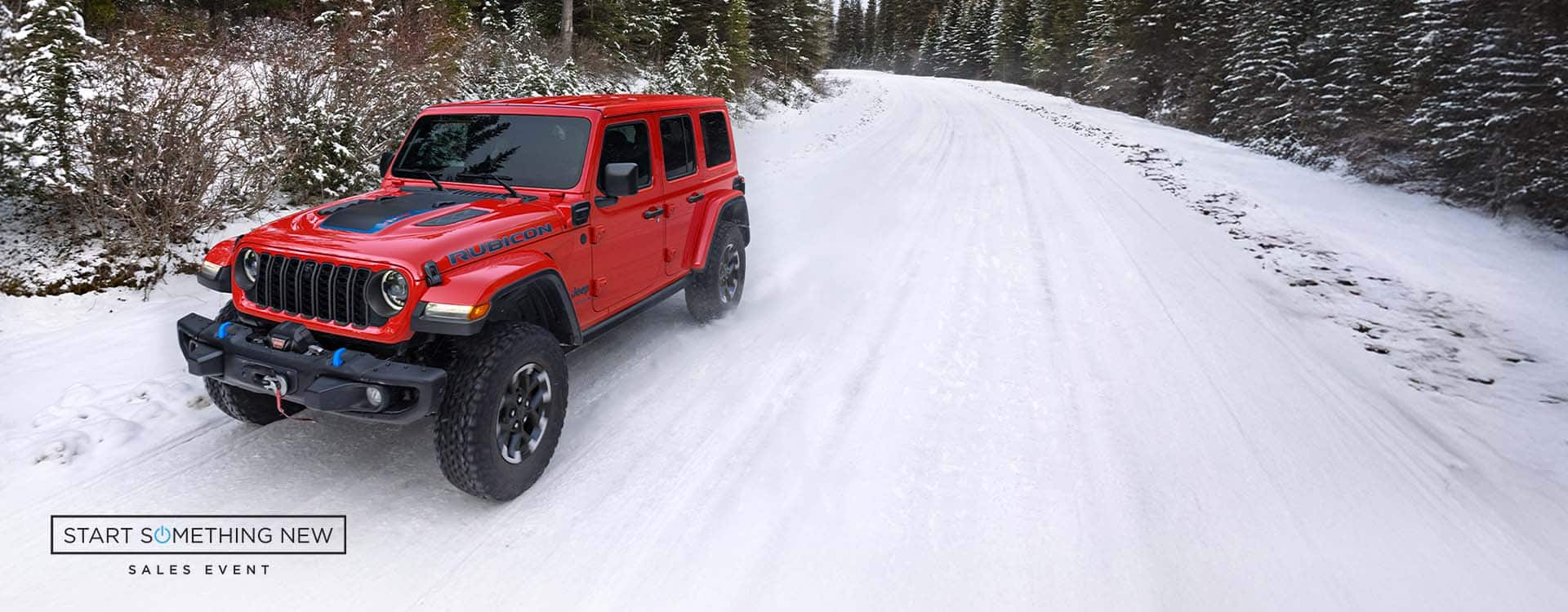 A red 2024 Jeep Wrangler Rubicon X 4xe traveling on a snow-covered road in a forest. Start Something New Sales Event.