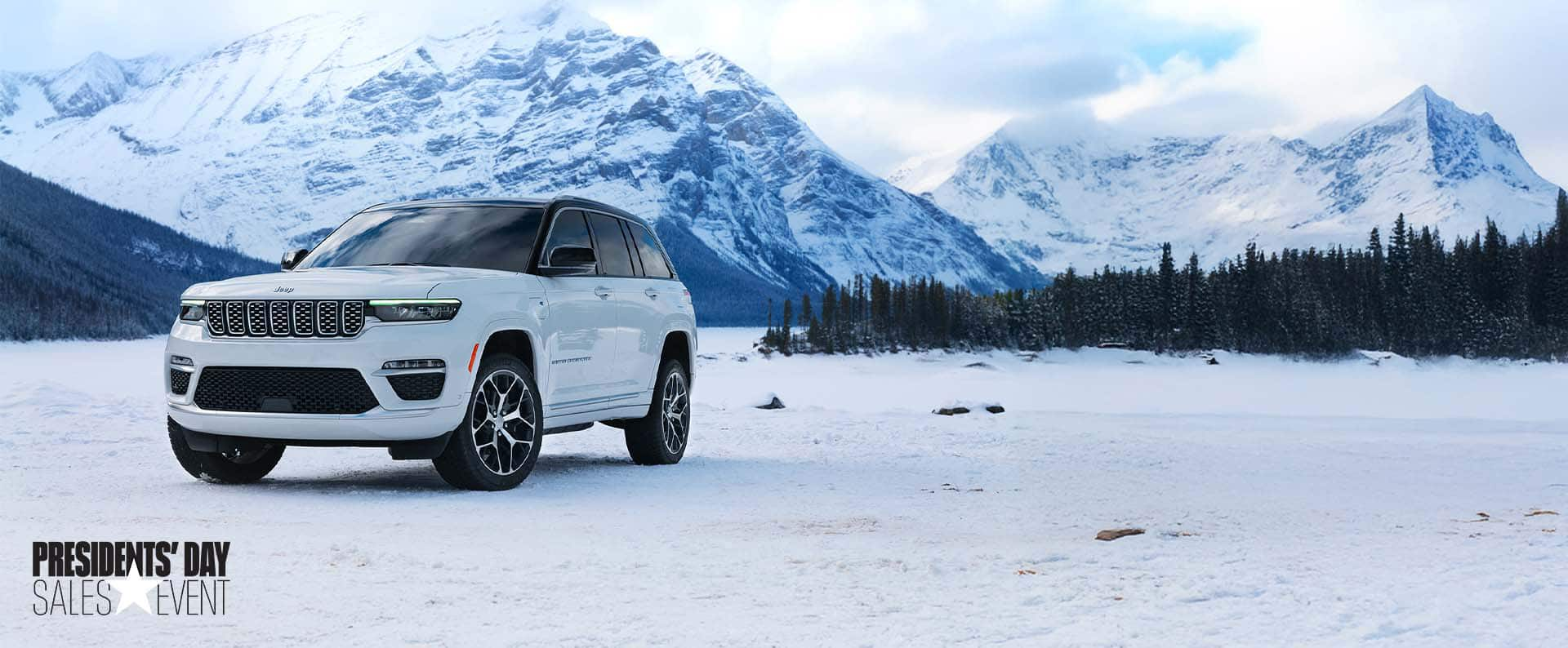 A 2025 Jeep Grand Cherokee model parked on a snowy clearing , with mountains in the background. President's day Event.