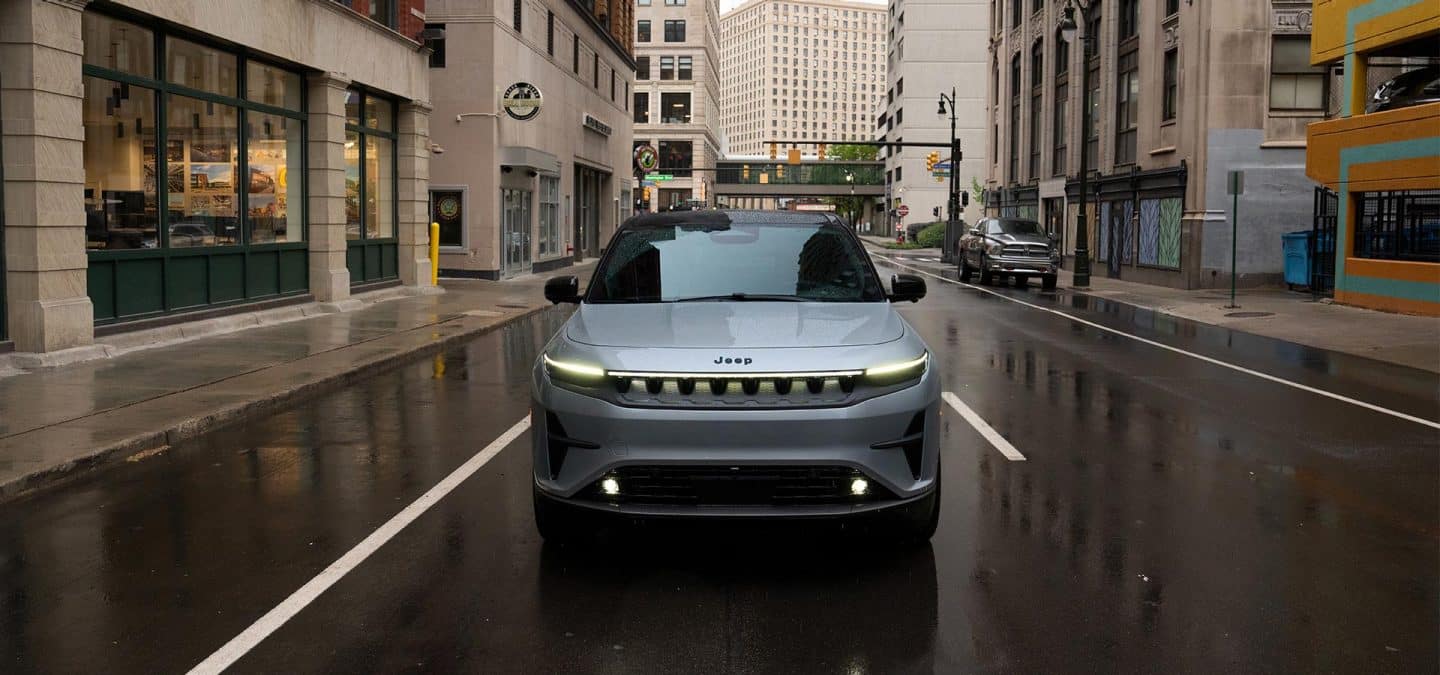 Display A silver 2025 Jeep Wagoneer S Launch Edition traveling down a city street.