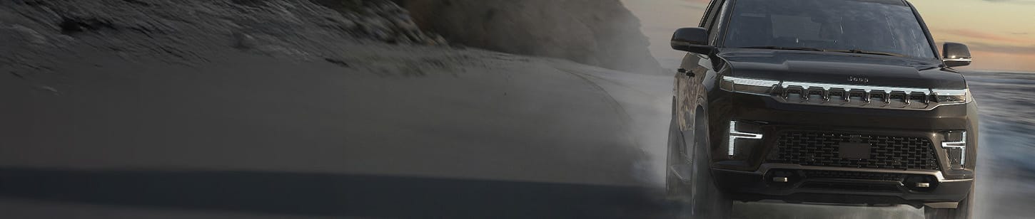 A head-on angle of a black 2026 Jeep Grand Wagoneer Summit Obsidian.