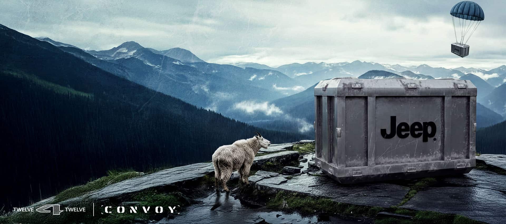 A gray steel crate with the Jeep Brand logo imprinted on its side sits atop the edge of a cliff. A white mountain goat stands nearby, looking over the crate. A second crate attached to a blue parachute floats down in the distance over mountains of forests. 12 for 12. Convoy.