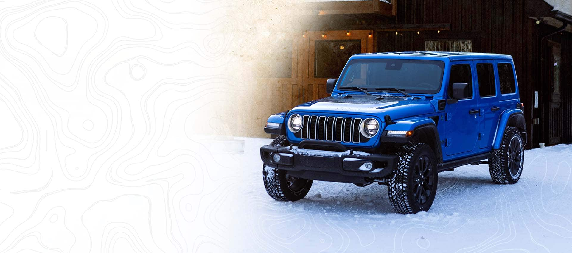 A blue 2025 Jeep Wrangler Backcountry 4xe parked on snow.