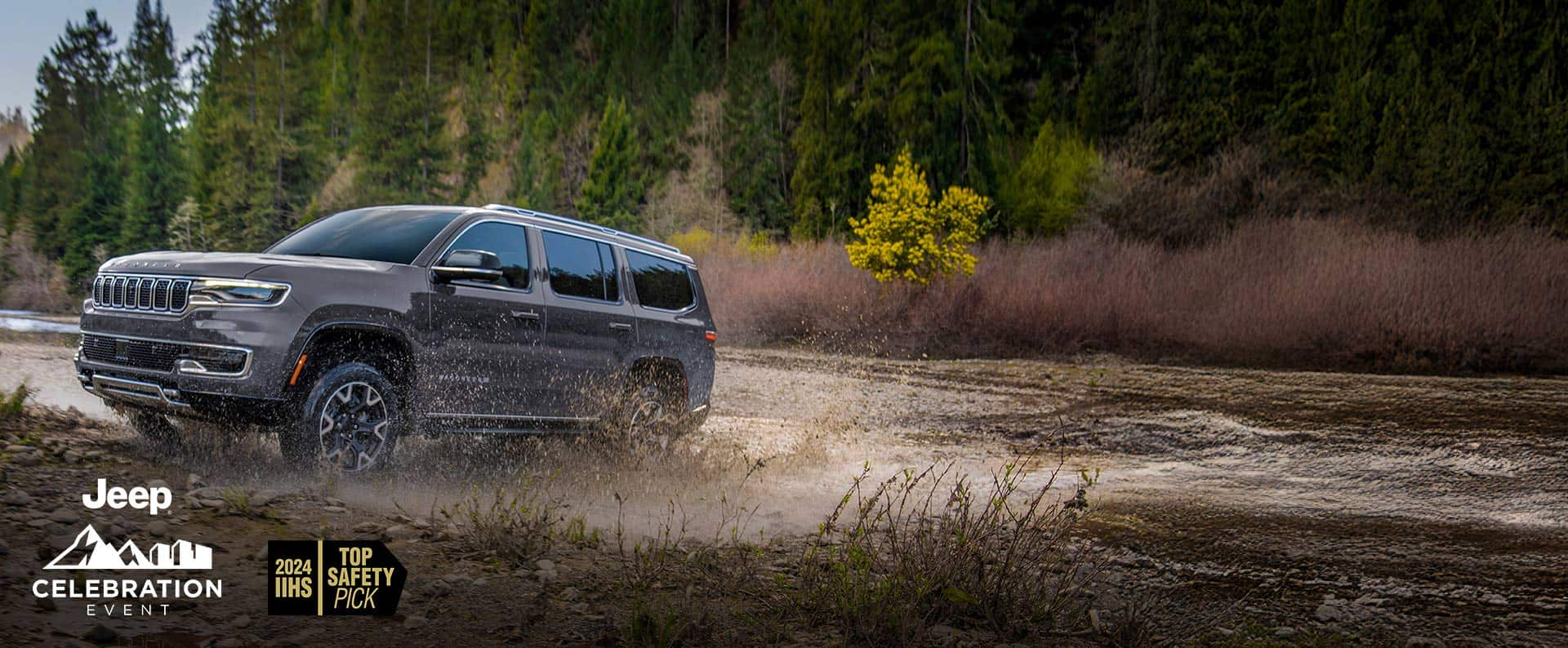 A gray 2024 Jeep Grand Wagoneer L Series 3 exiting a muddy stream off-road. Jeep Celebration Event. 2024 IIHS Top Safety Pick.