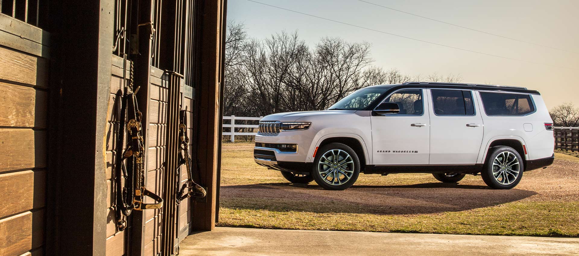 A white 2024 Jeep Grand Wagoneer Series 3 parked at a horse farm.