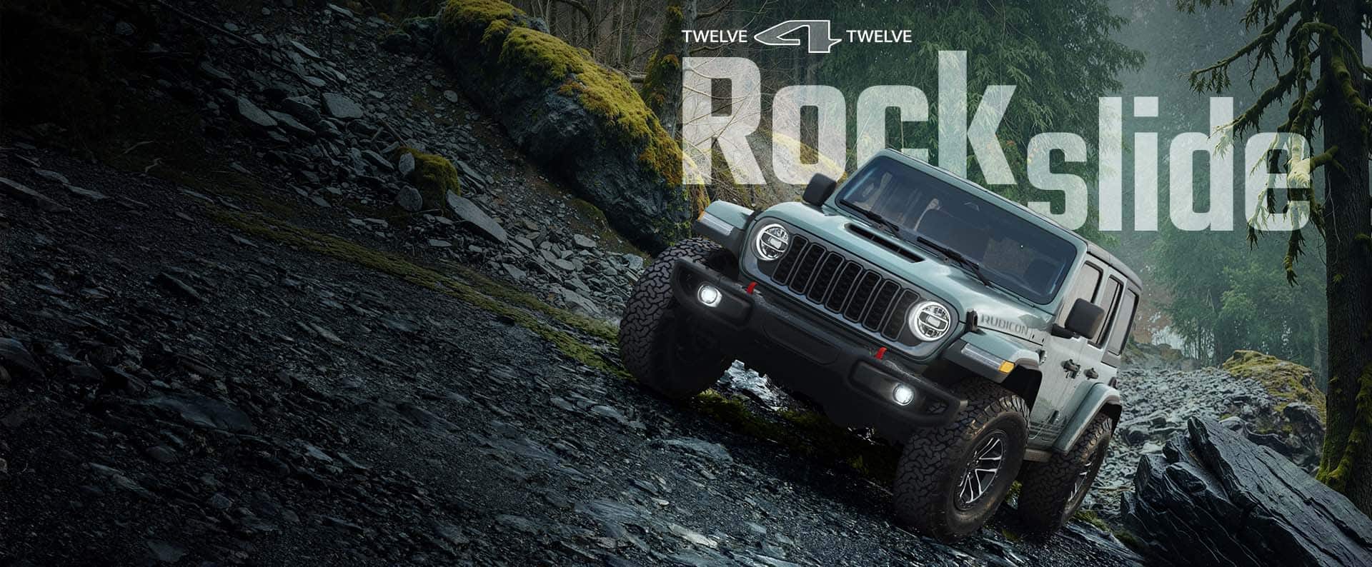 A blue-green 2026 Jeep Wrangler Rubicon Rockslide crawling horizontally over a steep, rocky trail off-road. 12 for 12. Rockslide.