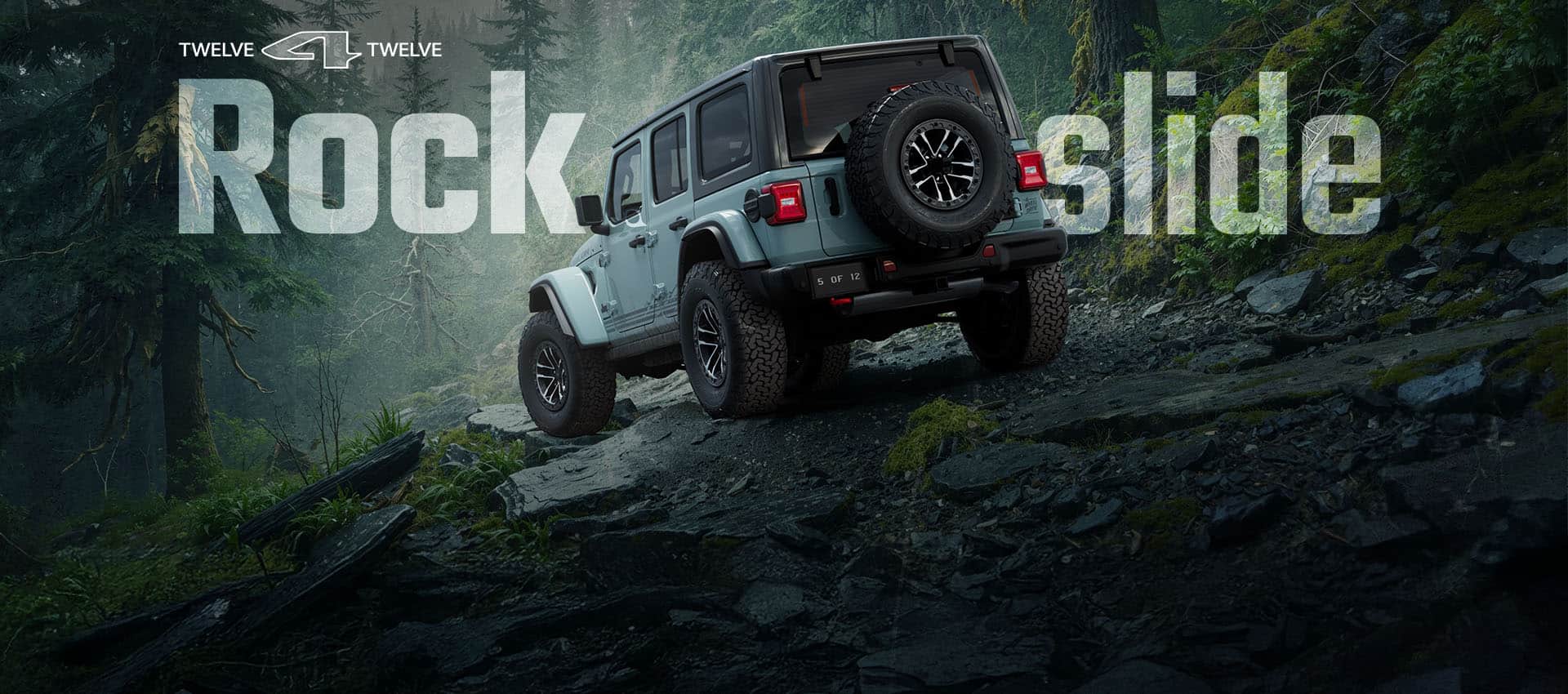 A driver-side rear angle of a blue-green 2026 Jeep Wrangler Rubicon Rockslide crawling down a rocky trail off-road. 12 for 12. Rockslide.