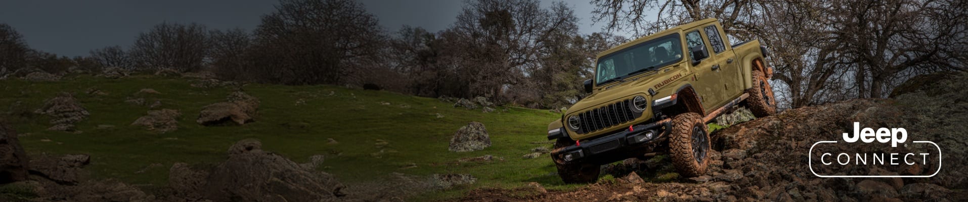 An olive green 2026 Jeep Gladiator Rubicon X descending a rugged, rocky trail off-road. The Jeep Connect logo.